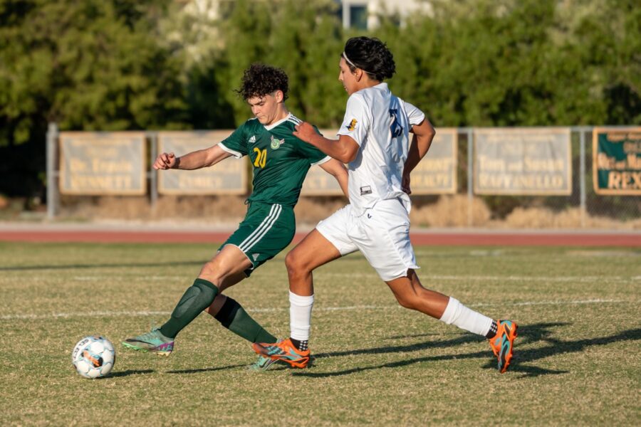 a couple of young men playing a game of soccer