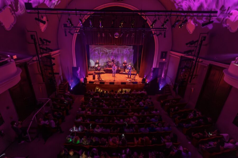 a large auditorium with a stage full of people