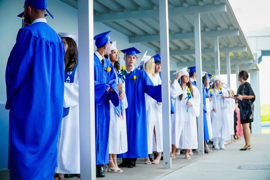 a group of people in blue graduation gowns