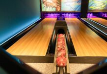 a bowling alley with bowling pins and bowling balls