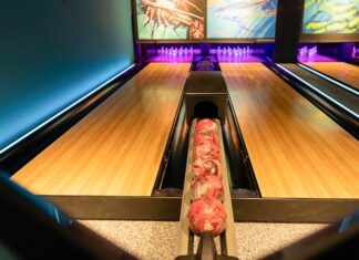 a bowling alley with bowling pins and bowling balls