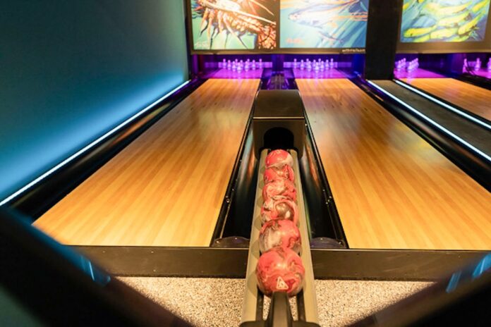 a bowling alley with bowling pins and bowling balls