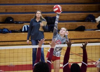 a group of young people playing a game of volleyball