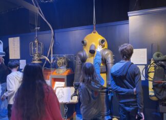 a group of people standing in front of a machine