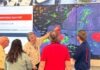 a group of people looking at a weather map