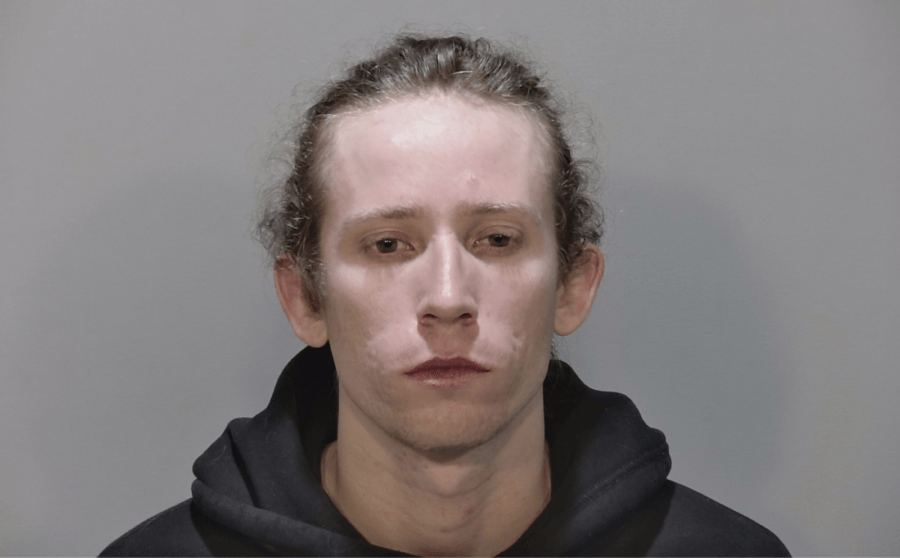 a mug shot of a man in a black hoodie