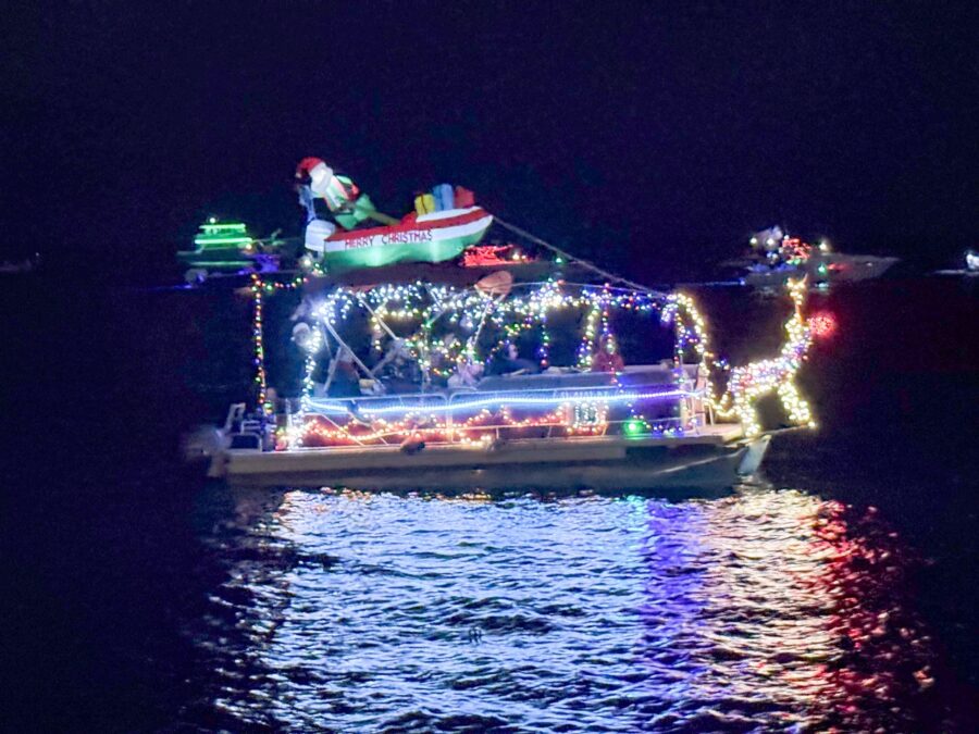 a boat decorated with christmas lights on the water