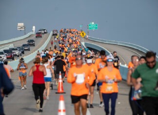 a large group of people running on a bridge