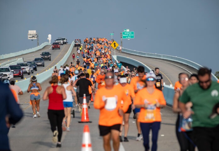 a large group of people running on a bridge