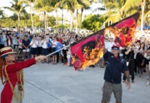 a man holding a flag in front of a crowd of people