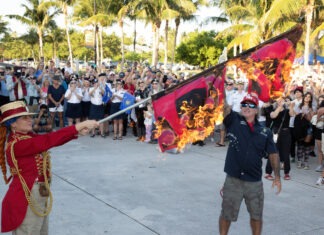 a man holding a flag in front of a crowd of people