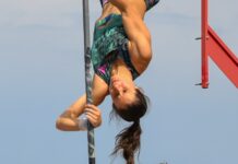 a woman doing a high jump on a pole