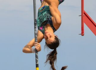 a woman doing a high jump on a pole