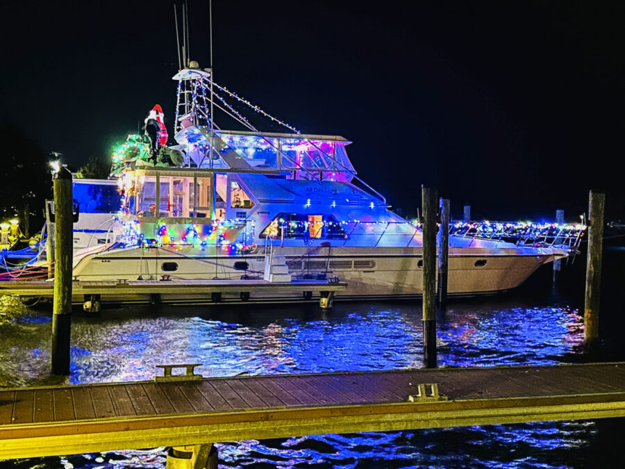 a boat is decorated with christmas lights on the water