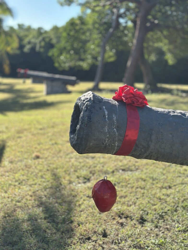 a red ball is in the air near a pipe