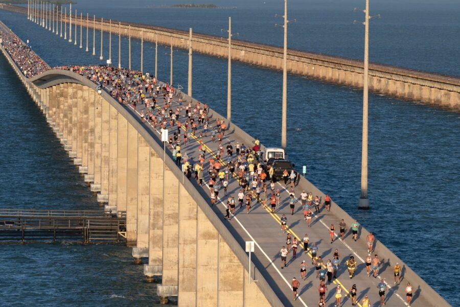 a large group of people running across a bridge