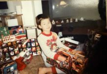 a young boy sitting on the floor in front of a television