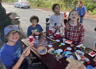 a group of children sitting around a table