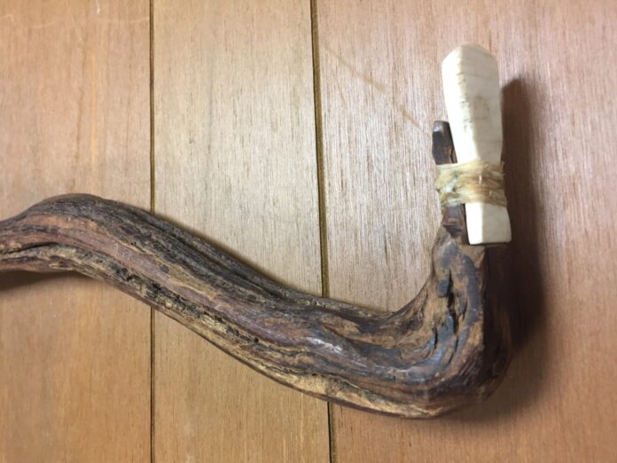 a piece of wood with a white cord attached to it