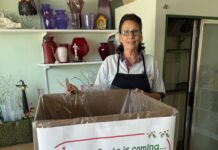 a woman standing in front of a box of toys