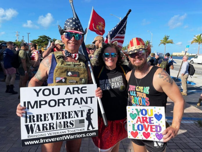 a group of people standing next to each other holding signs