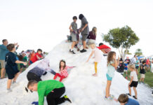 a group of children playing in the snow