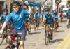 a group of people riding bikes down a street