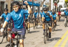 a group of people riding bikes down a street