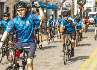 a group of people riding bikes down a street