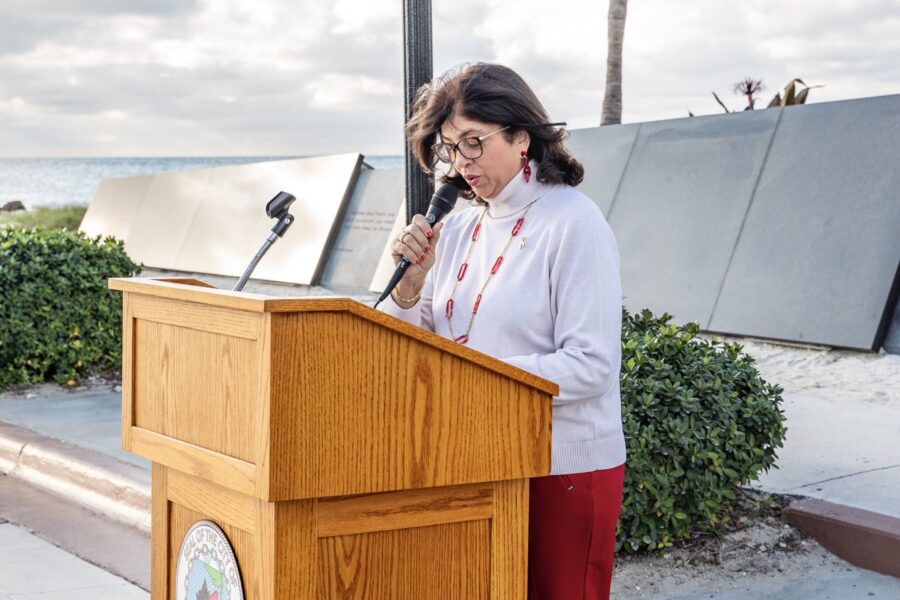 a woman standing at a podium with a microphone