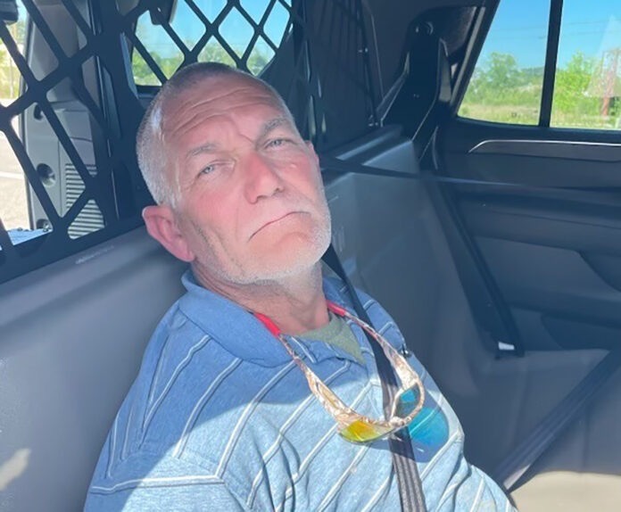 a man sitting in the passenger seat of a car