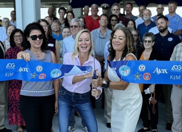 a group of people holding a blue ribbon