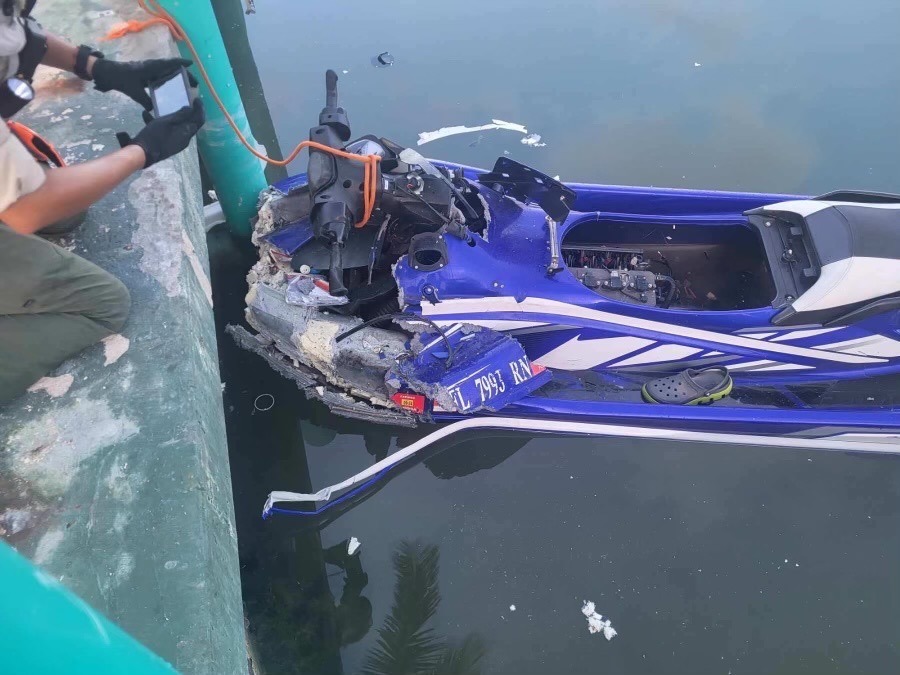 a blue and white jet ski sitting on top of a body of water