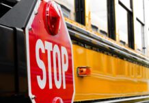 a close up of a stop sign on a school bus