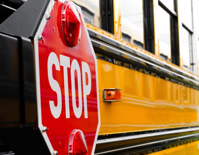 a close up of a stop sign on a school bus