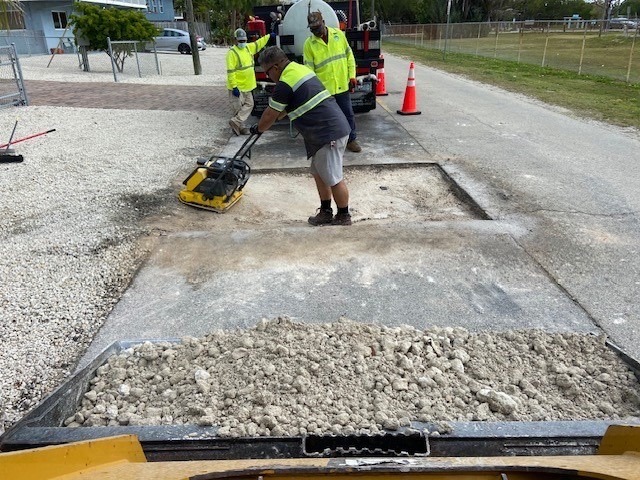 a man is cleaning a parking lot with a machine