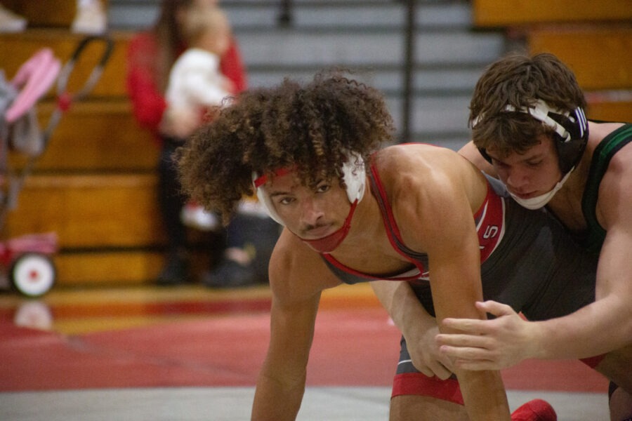 a wrestling match with two wrestlers on the ground