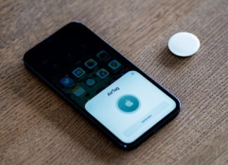 an iphone sitting on top of a wooden table