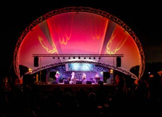 a stage with a band on it at night