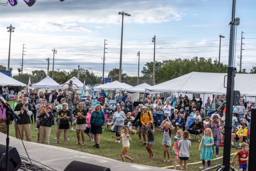 a crowd of people standing around a stage