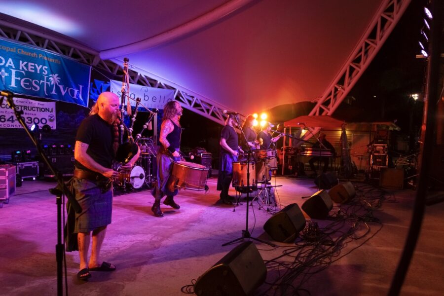 a group of people playing instruments on a stage