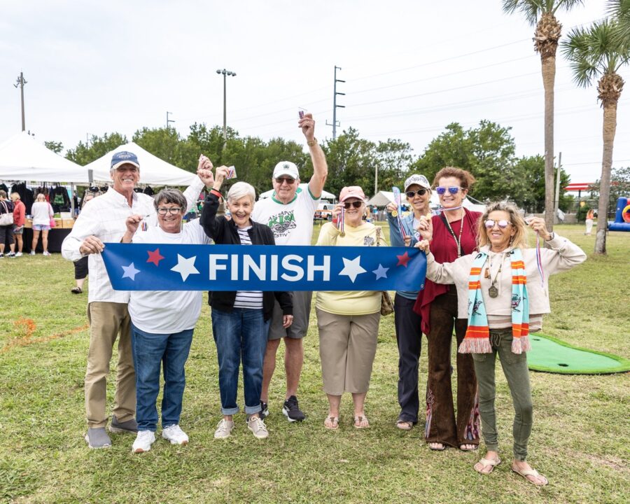 a group of people holding a finish sign