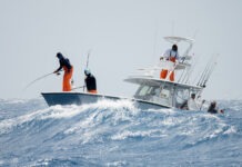 a group of people on a boat in the ocean