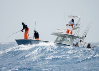 a group of people on a boat in the ocean