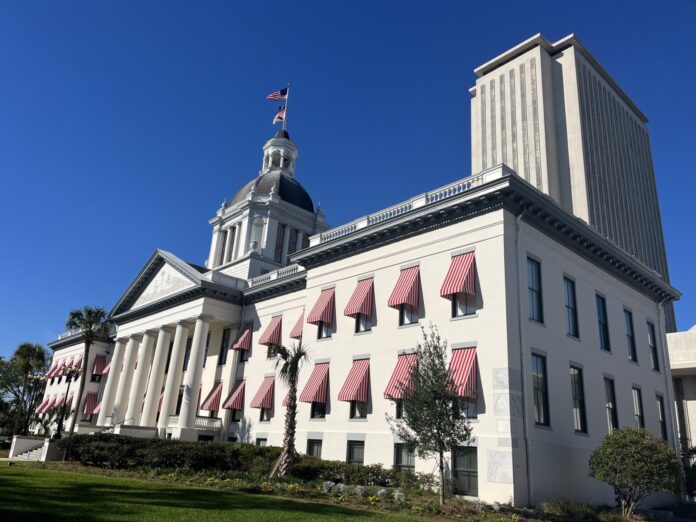 a large white building with a flag on top of it