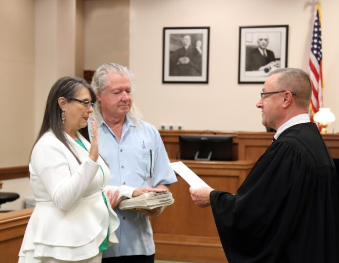 a judge and a woman standing in a courtroom