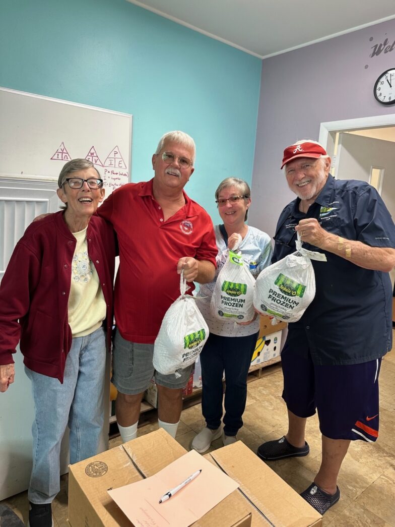 a group of people holding bags of food