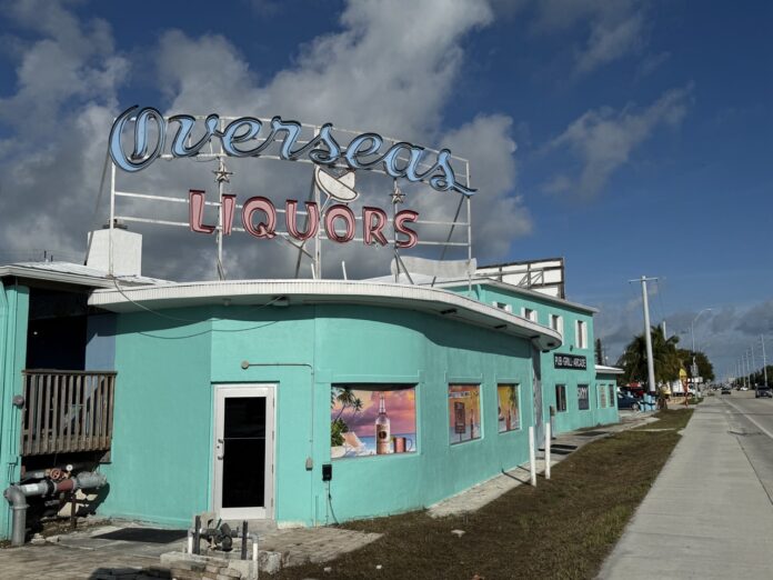 a blue building with a sign on top of it