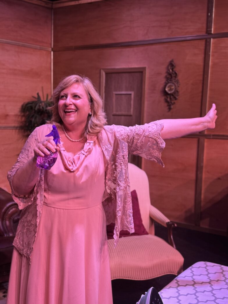 a woman in a pink dress standing in a room