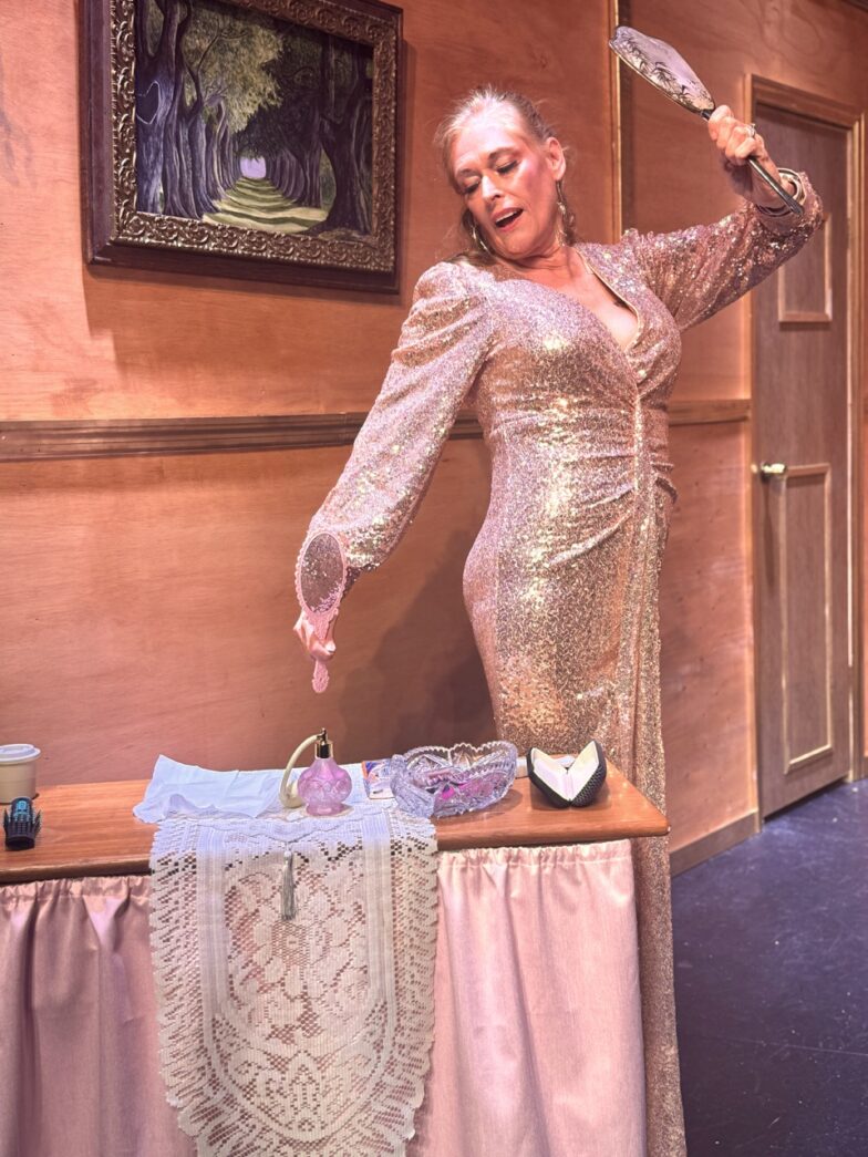 a woman in a gold dress standing on top of a table